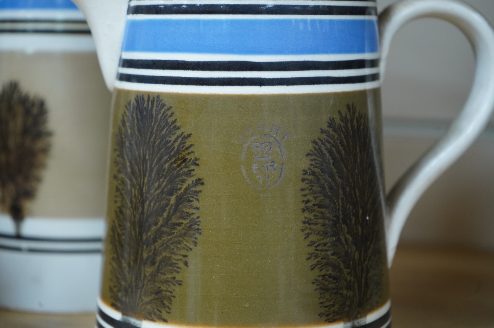 Three early 19th century Mocha ware jugs and a mug, largest 16cm high